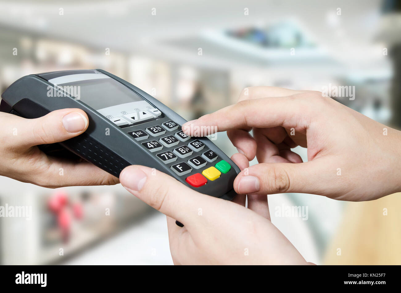 Hand with credit card swipe through terminal for sale in supermarket