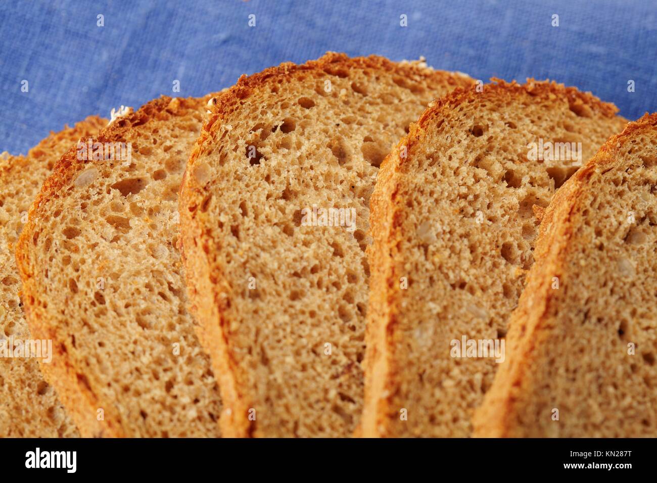 Whole Wheat Bread on blue background Stock Photo - Alamy