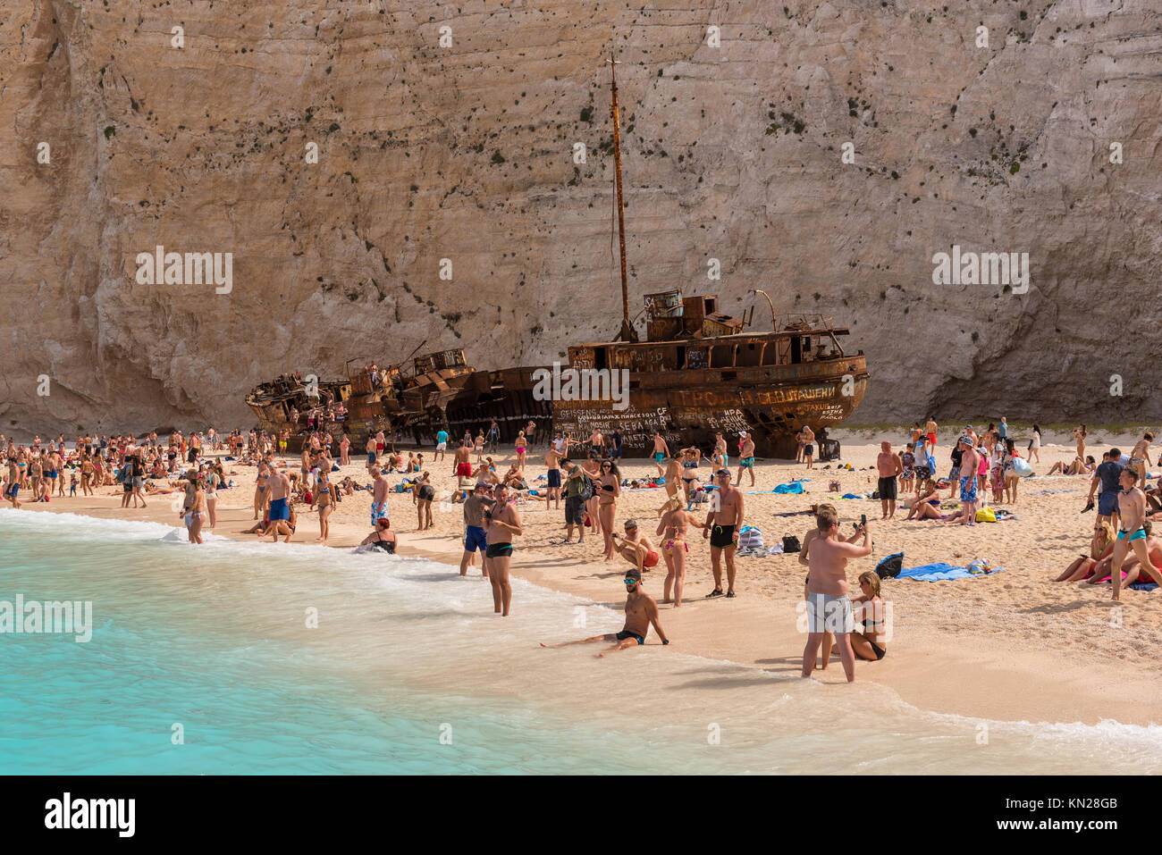 ZAKYNTHOS, GREECE, September 27, 2017: Tourists relaxing on the Navagio beach with a shipwreck on the island of Zakynthos. Greece. Stock Photo
