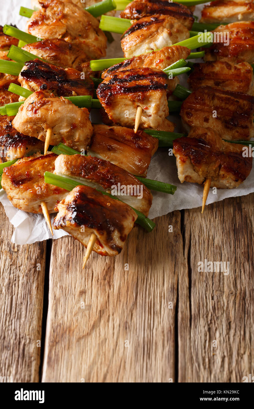 Dakkochi, Korean Chicken on a Stick close-up on the table. vertical ...