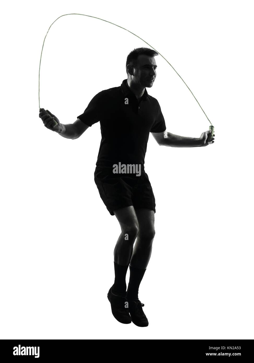 one man exercising jumping rope in studio silhouette isolated on white background Stock Photo