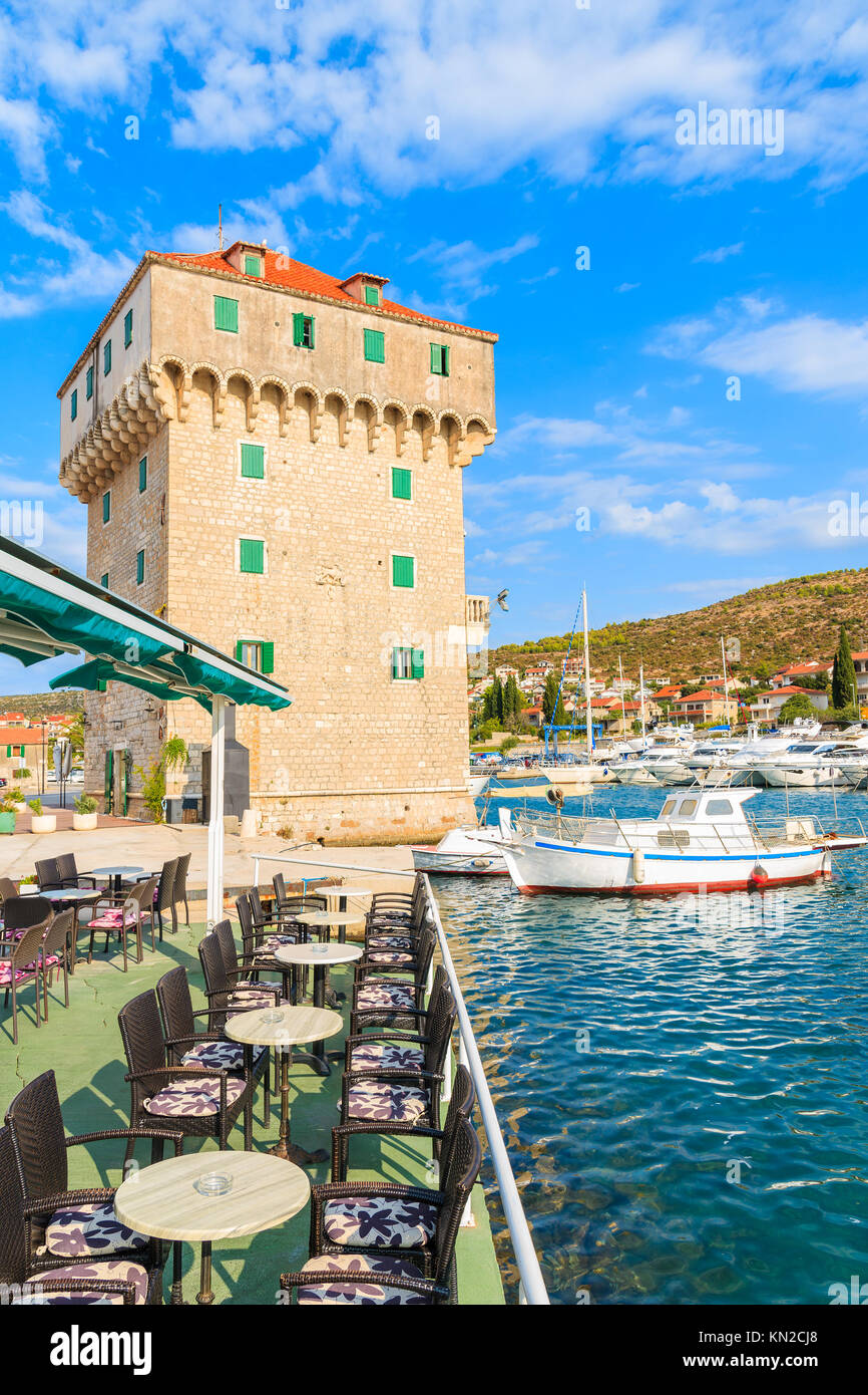 Old historic tower and fishing boat in Marina Agana port, Dalmatia, Croatia Stock Photo