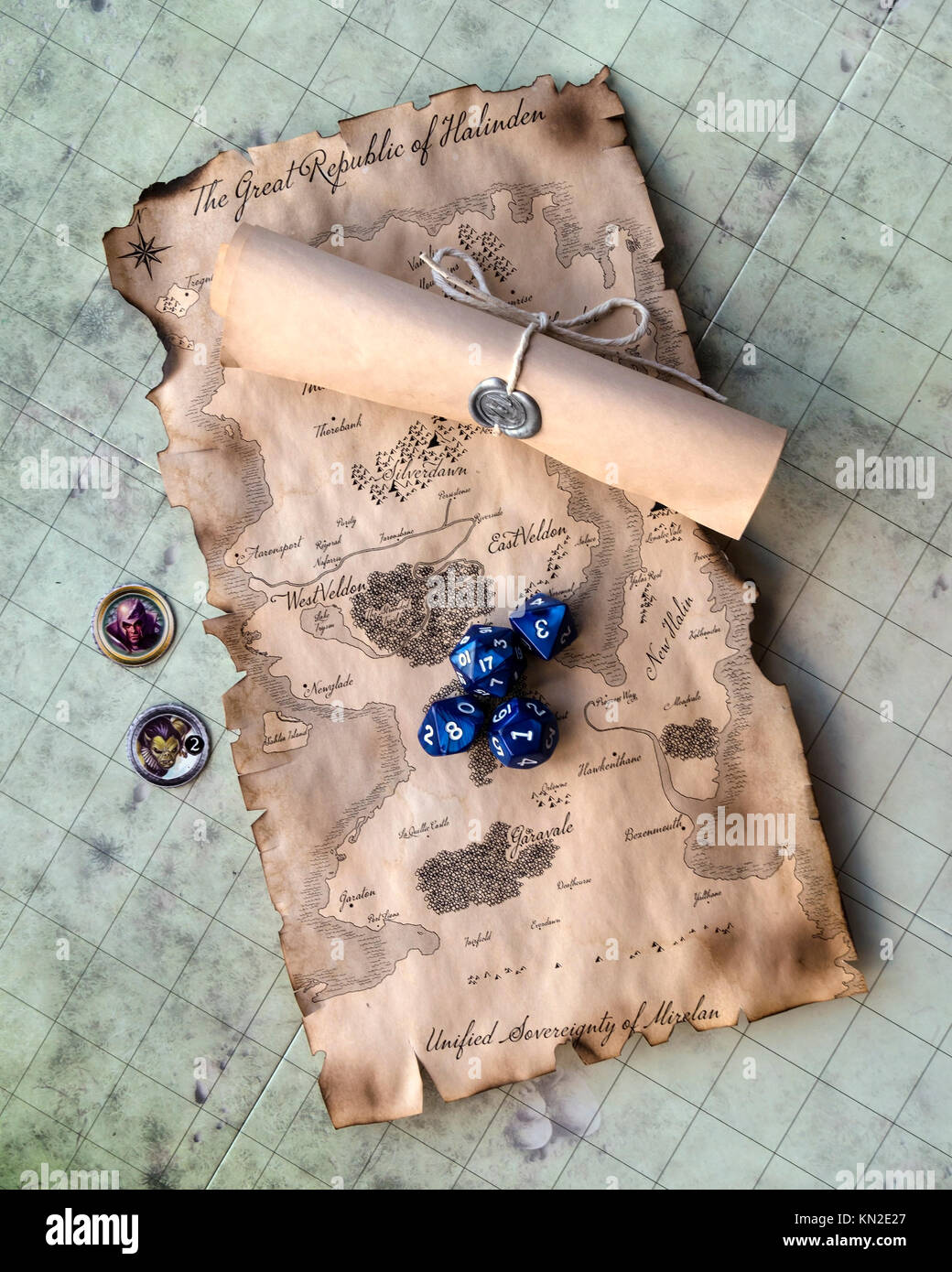 Fantasy roll playing game map with sealed scroll, dice and counters on game board Stock Photo