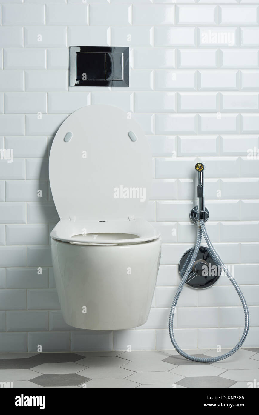 Modern clean white toilet seat in bathroom with elegant tile Stock Photo
