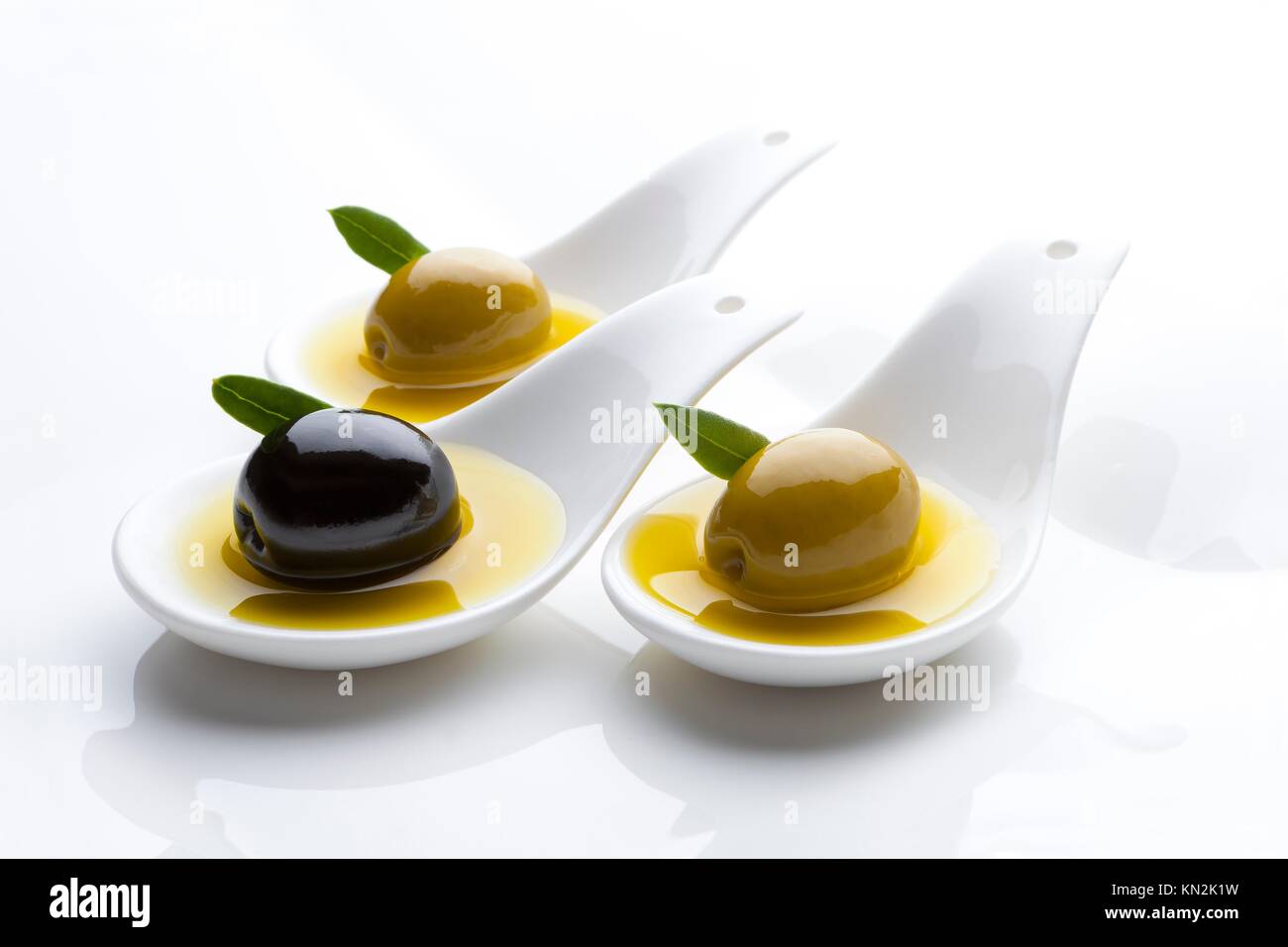 three tablespoons olive tasting with three Stock Photo - Alamy