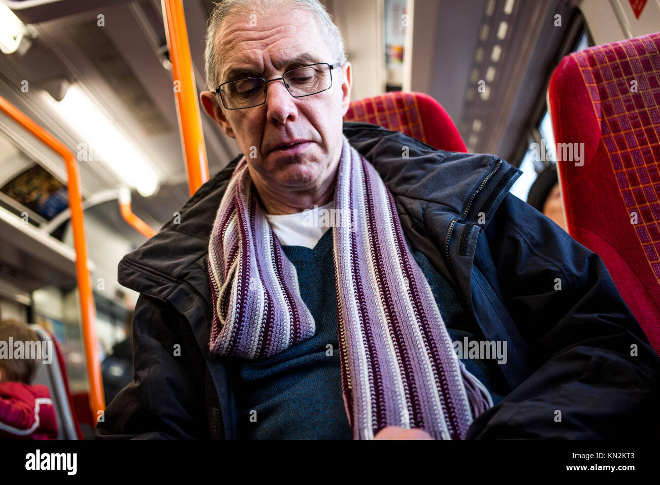 Candid Portrait of A Commuter Traveling on a Train In England Stock Photo