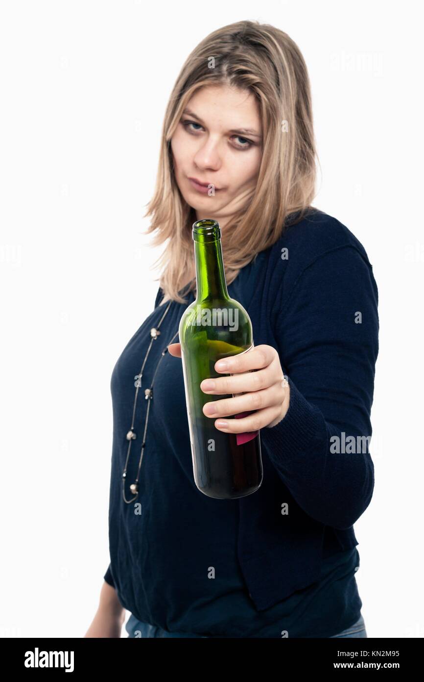 Frustrated drunk woman holding bottle of wine, isolated on white