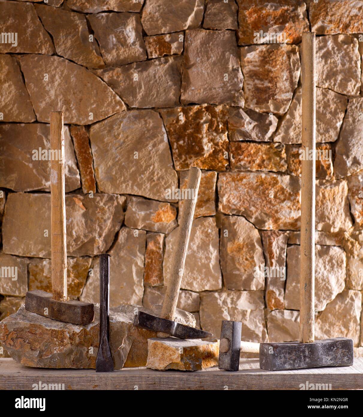 Hammer mason tools of stonecutter masonry work in a contruction stone