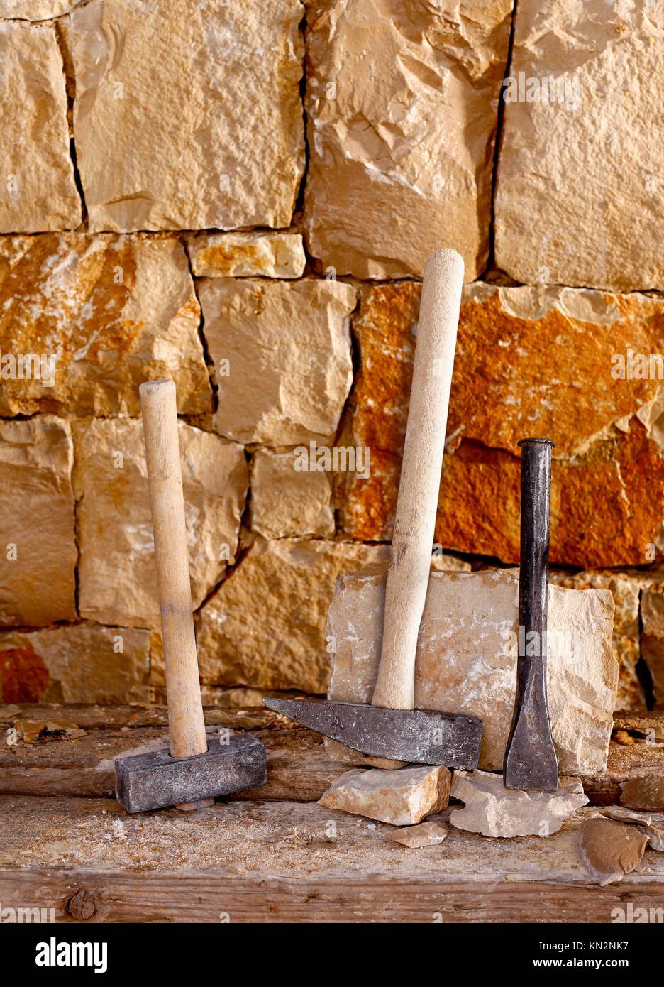 Hammer mason tools of stonecutter masonry work in a contruction stone wall Stock Photo Alamy