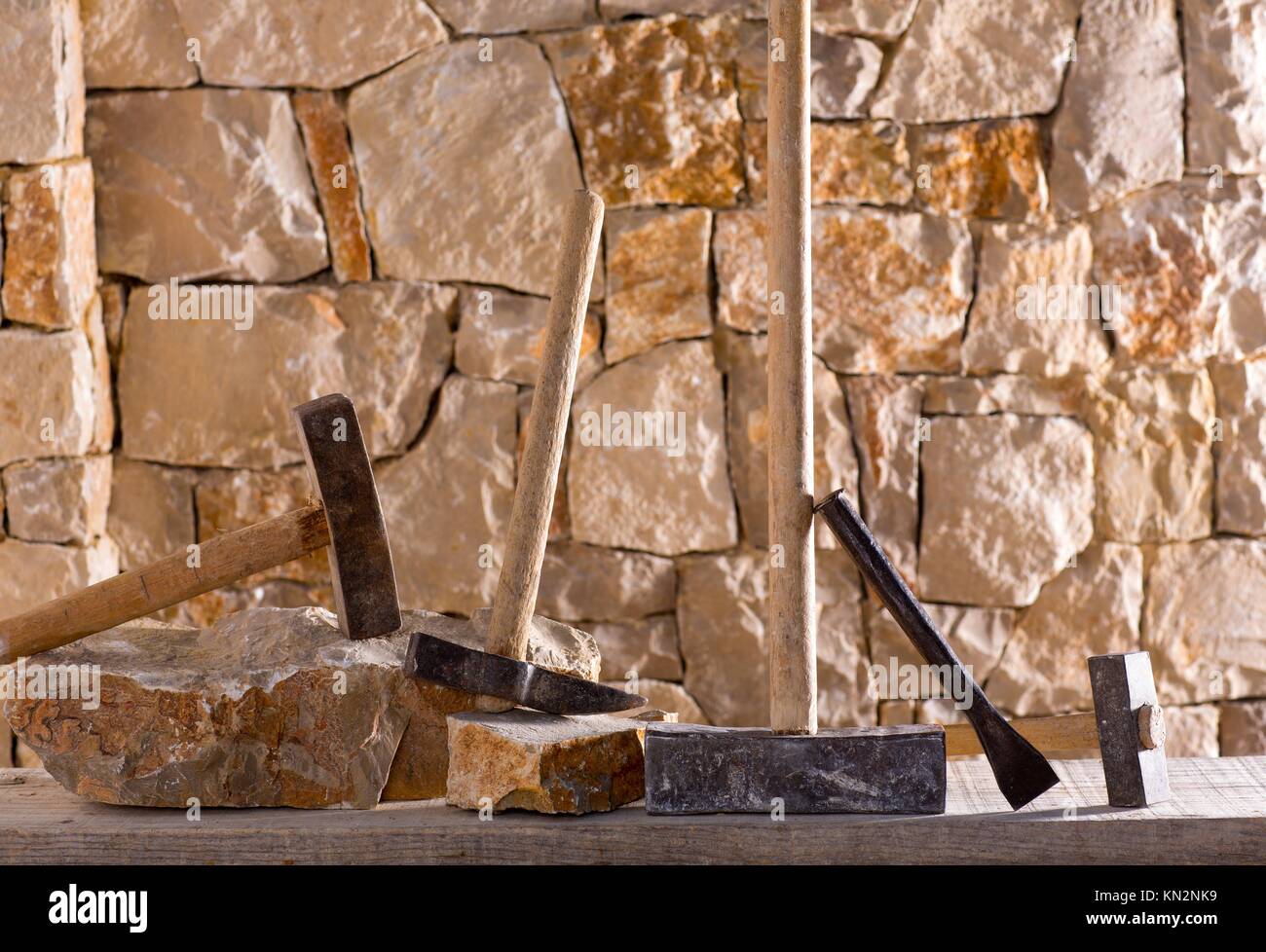 Hammer mason tools of stonecutter masonry work in a contruction stone