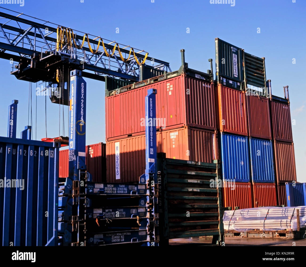 Shipping containers stacked at a container terminal and docks Stock Photo