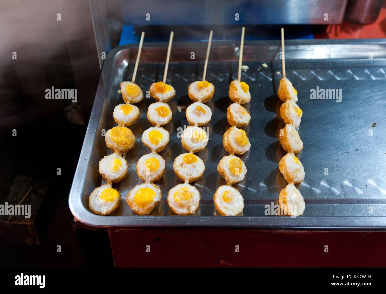 sticked quail eggs on street food stall on Wangfujing Snack Street in Dongcheng District