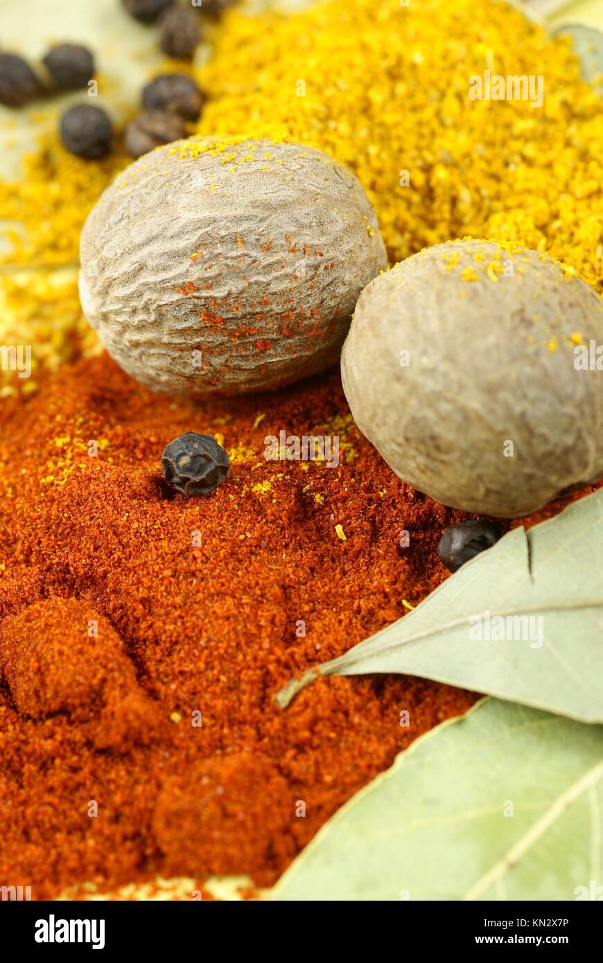 Ground pepper, curry, nutmegs, bay leaves and black pepper Stock Photo