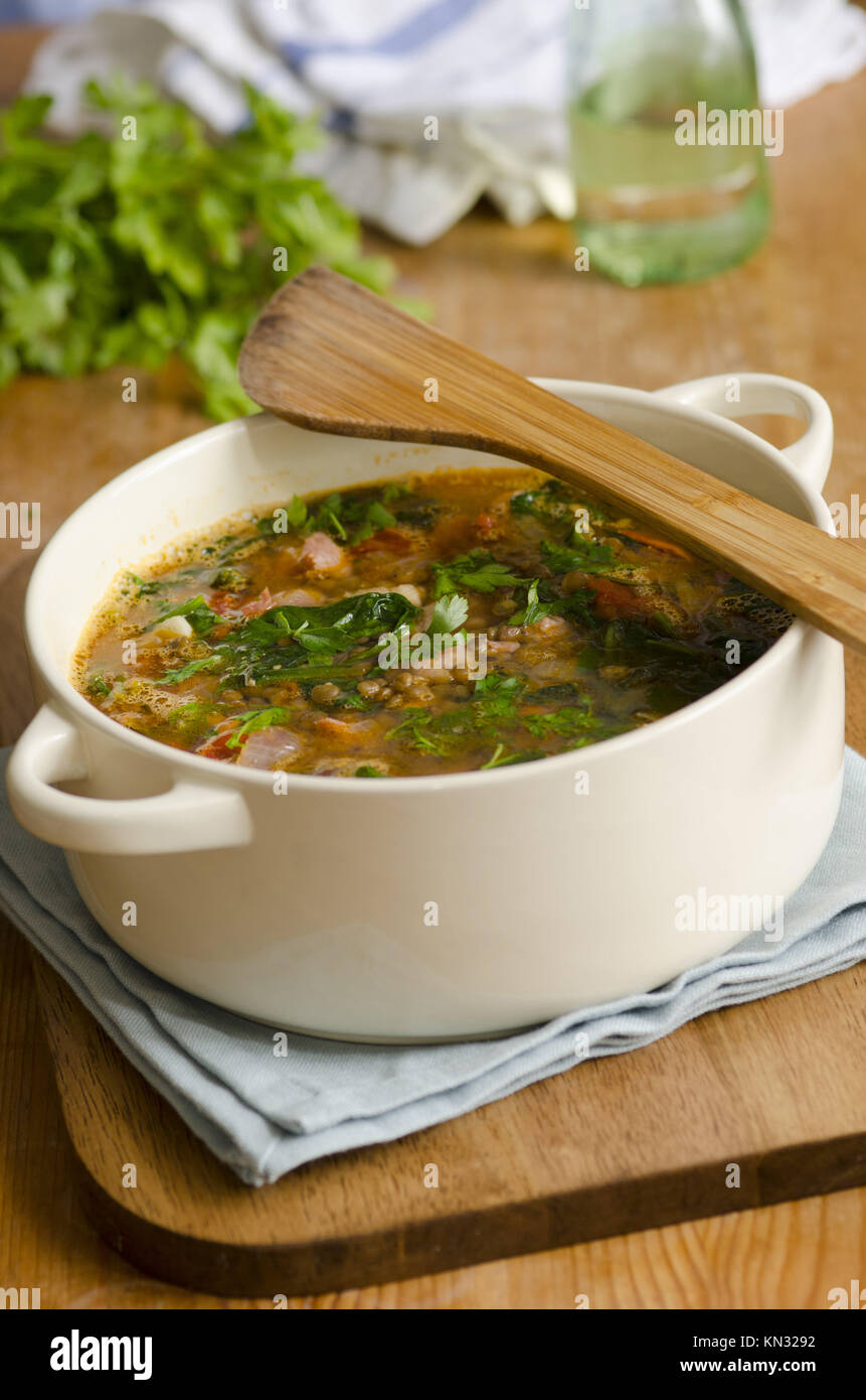 Delicious puy lentil, spinach and bacon soup. Stock Photo
