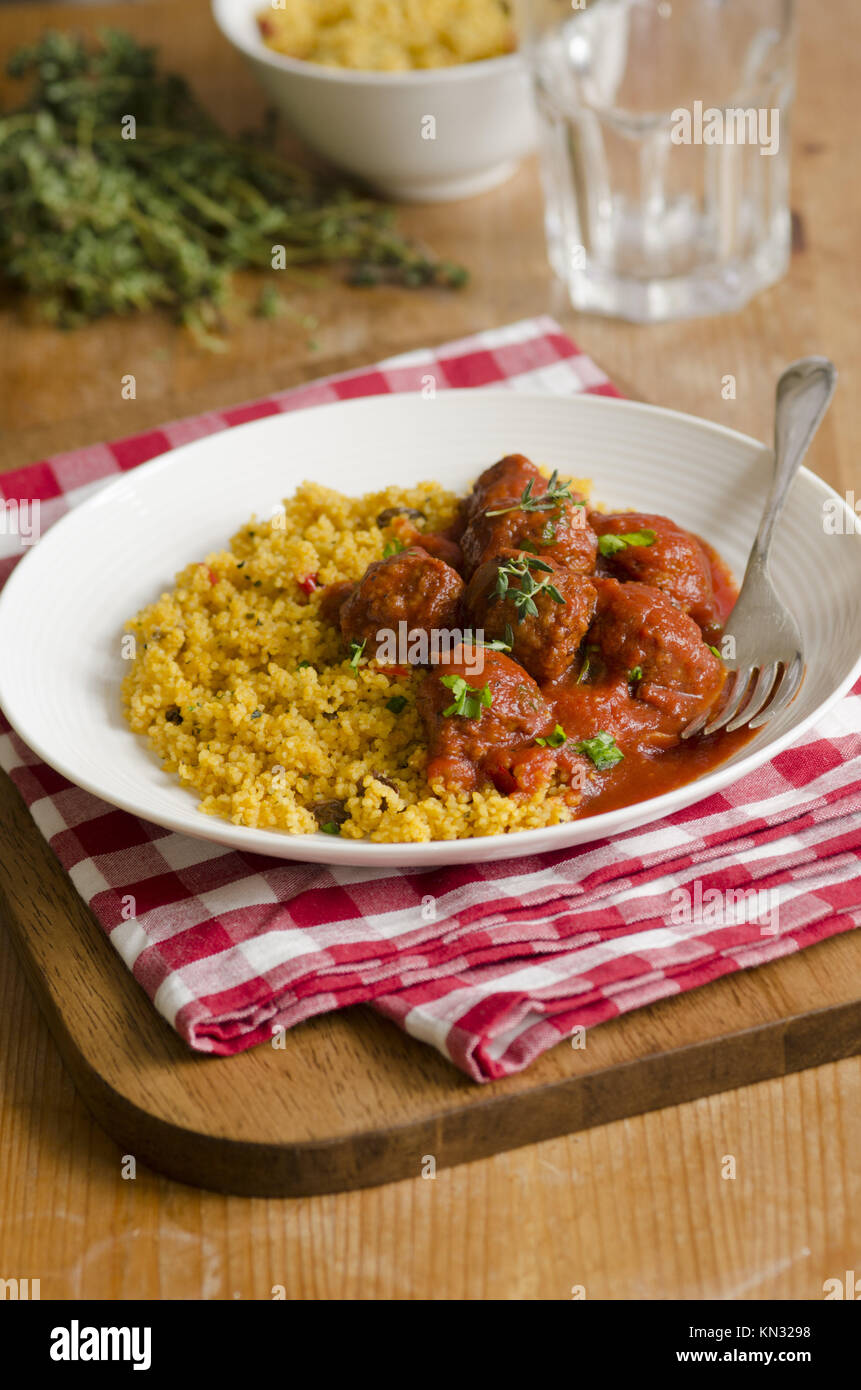 Moroccan spiced meatballs in tomato sauce with couscous Stock Photo Alamy