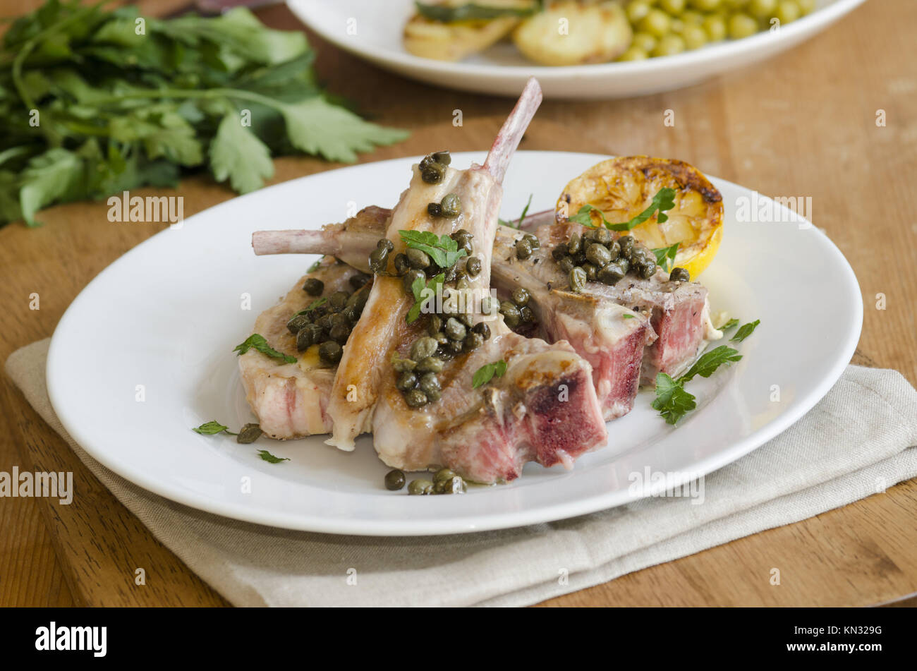 Grilled lamb chops with anchovies and capers on a plate Stock Photo Alamy