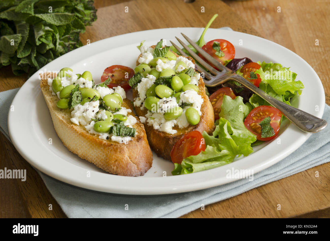 Broad bean and feta cheese toasts with leaf salad Stock Photo Alamy