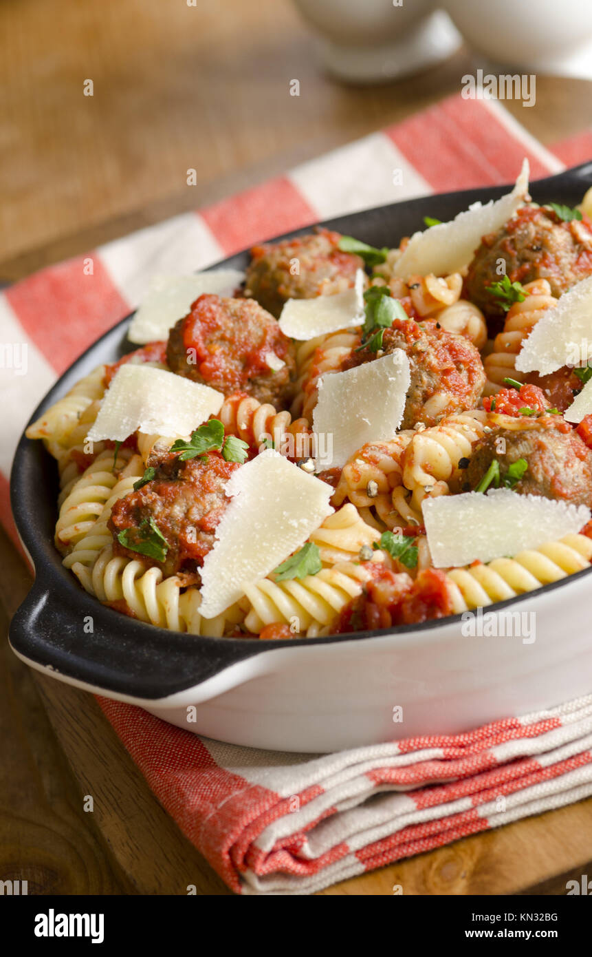 Meatballs with fusilli in tomato sauce topped with grated Parmesan ...