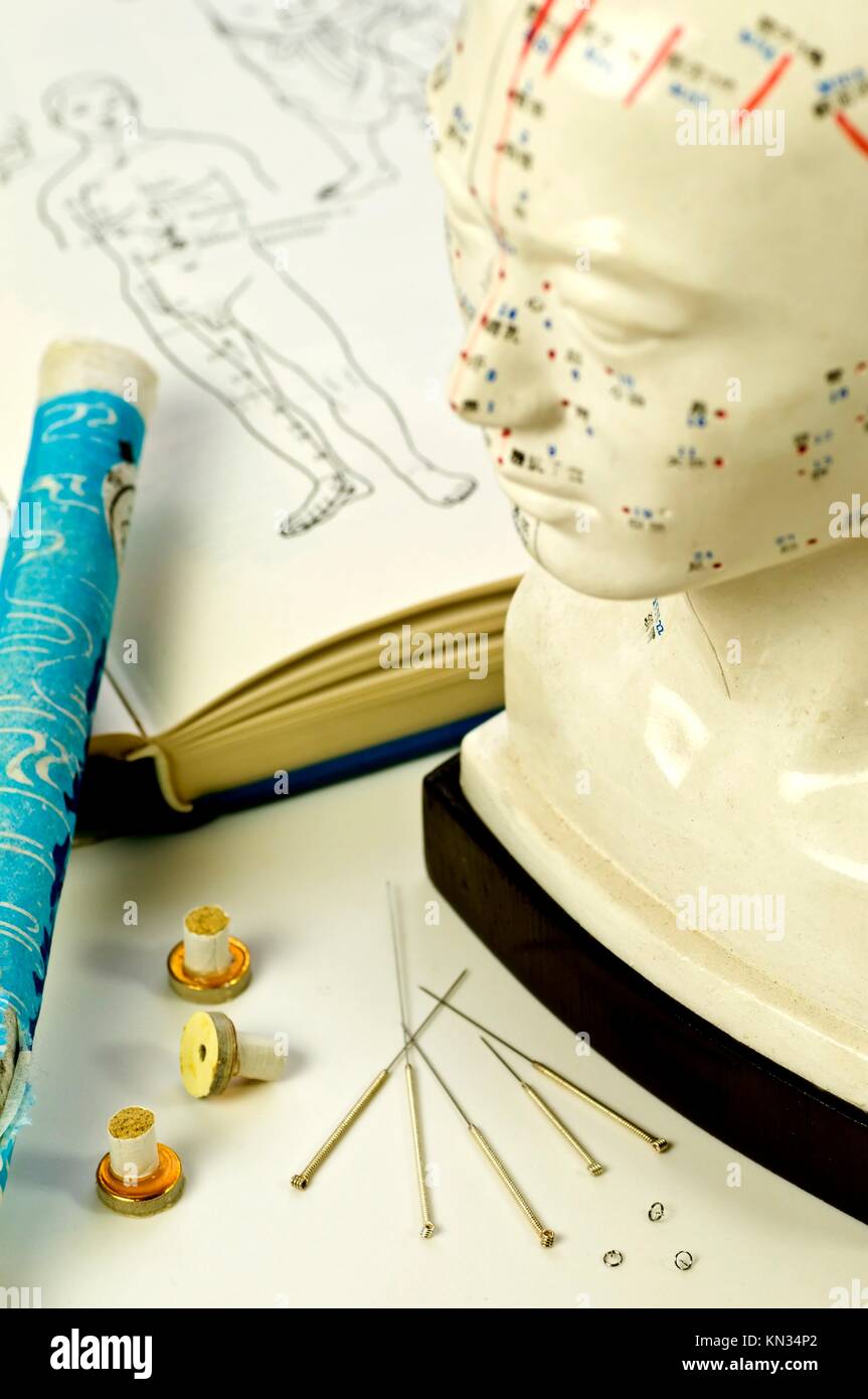 Acupuncture needles, head model, textbook and moxa roll Stock Photo Alamy