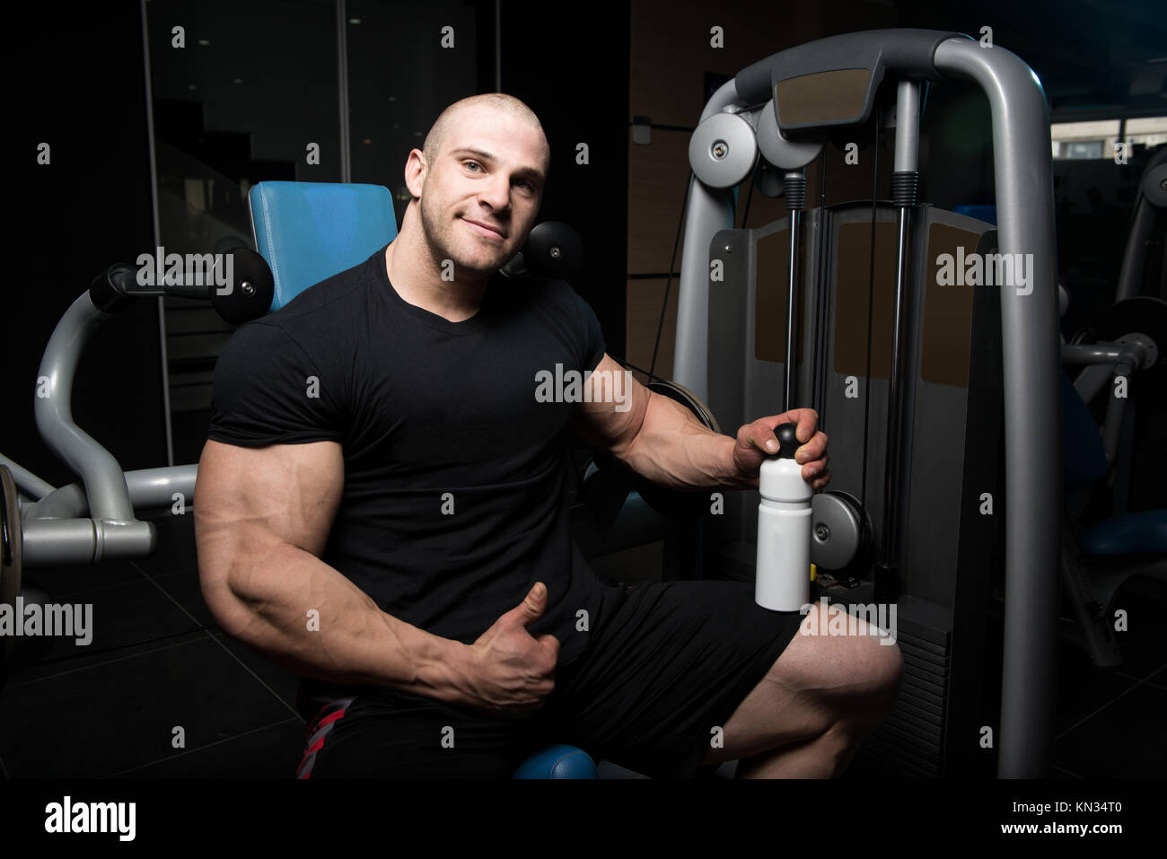 Muscular Man Resting After Exercise And Drinking From Shaker Stock