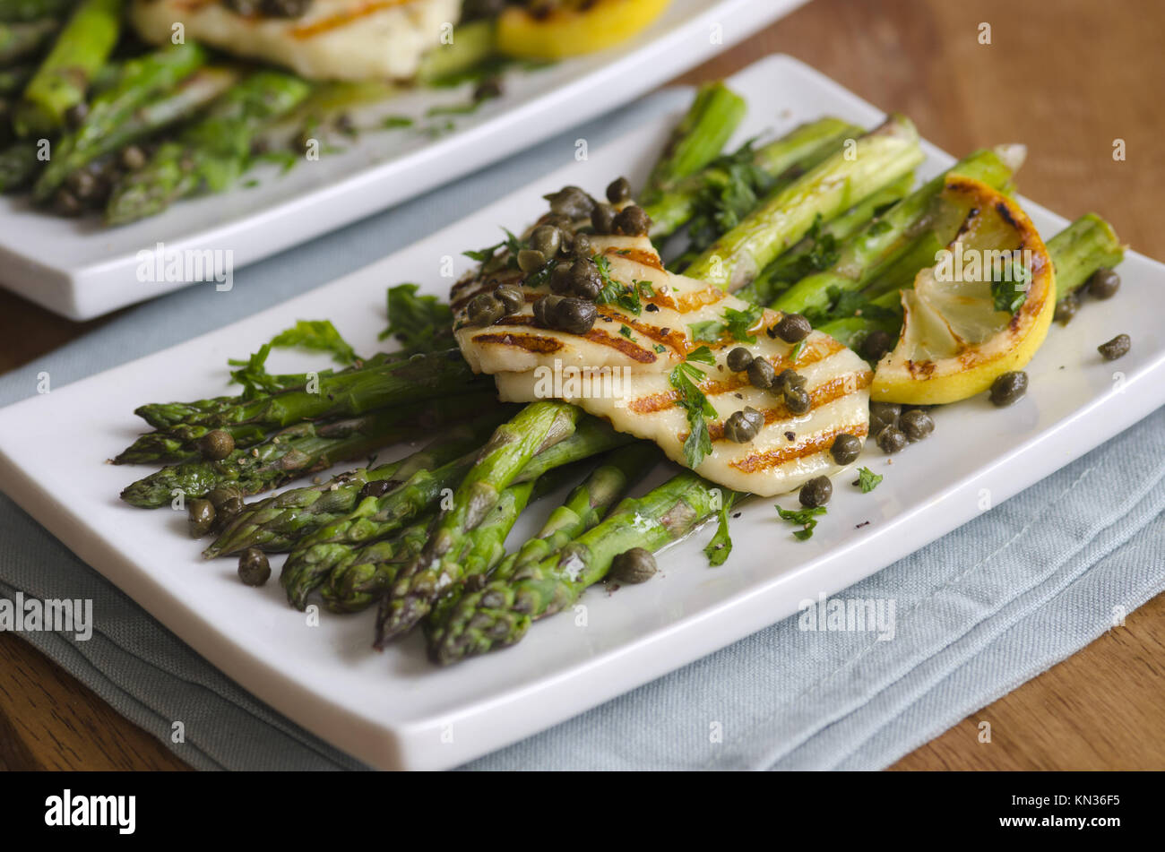 BBQ asparagus and Halloumi with crispy capers. Stock Photo