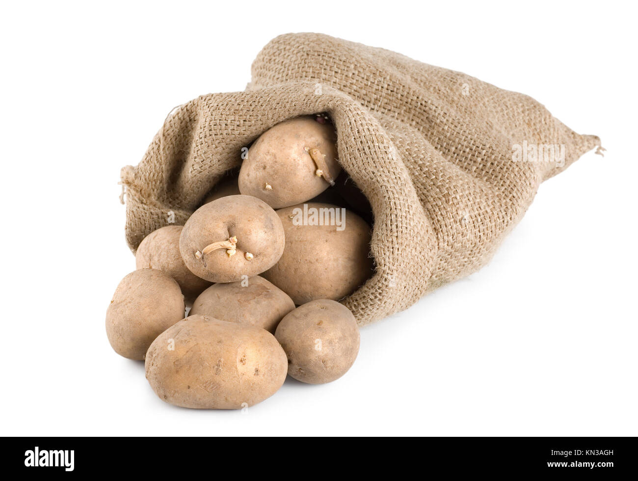 Raw potatoes in a hessian sack isolated on a white background. Stock Photo