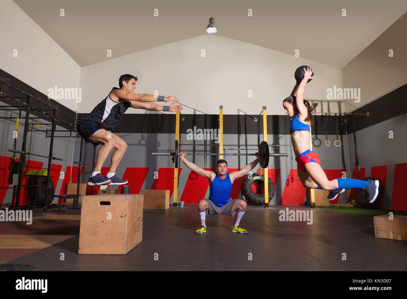 gym people group workout barbells slam balls and jump exercises Stock