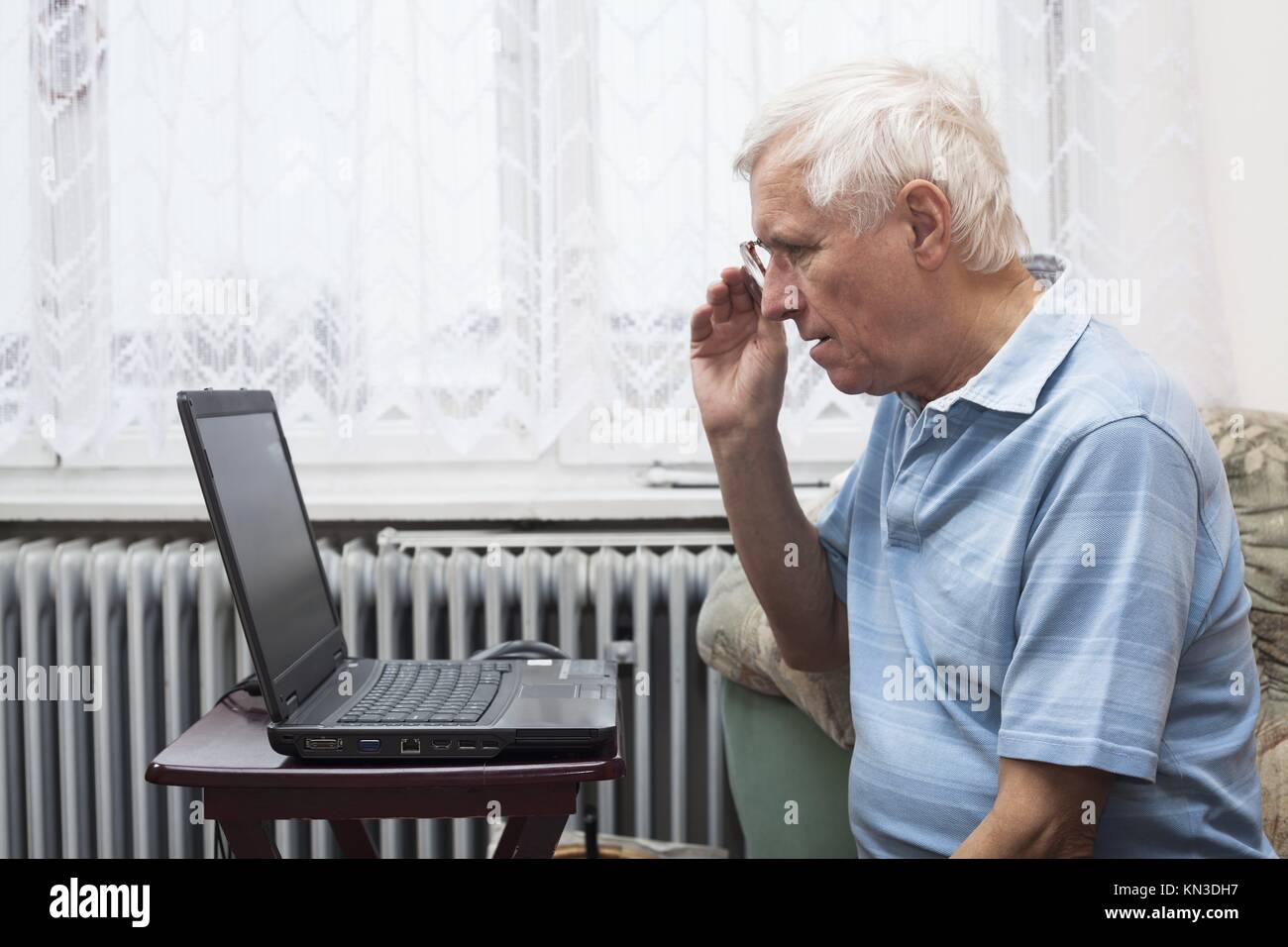Senior man learning to use a computer at home. Stock Photo
