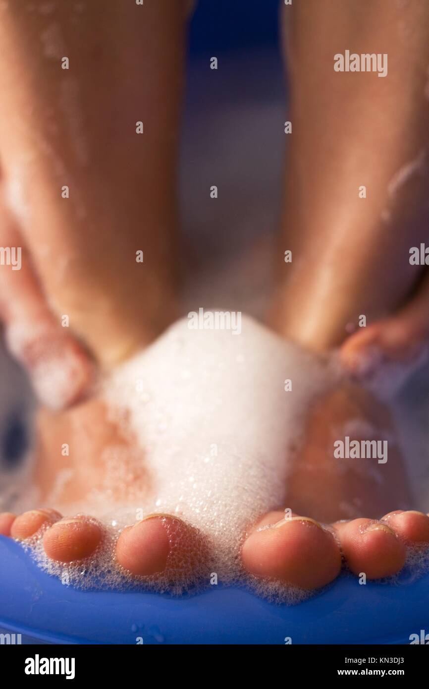 Detail of female feet in soap bath Stock Photo Alamy