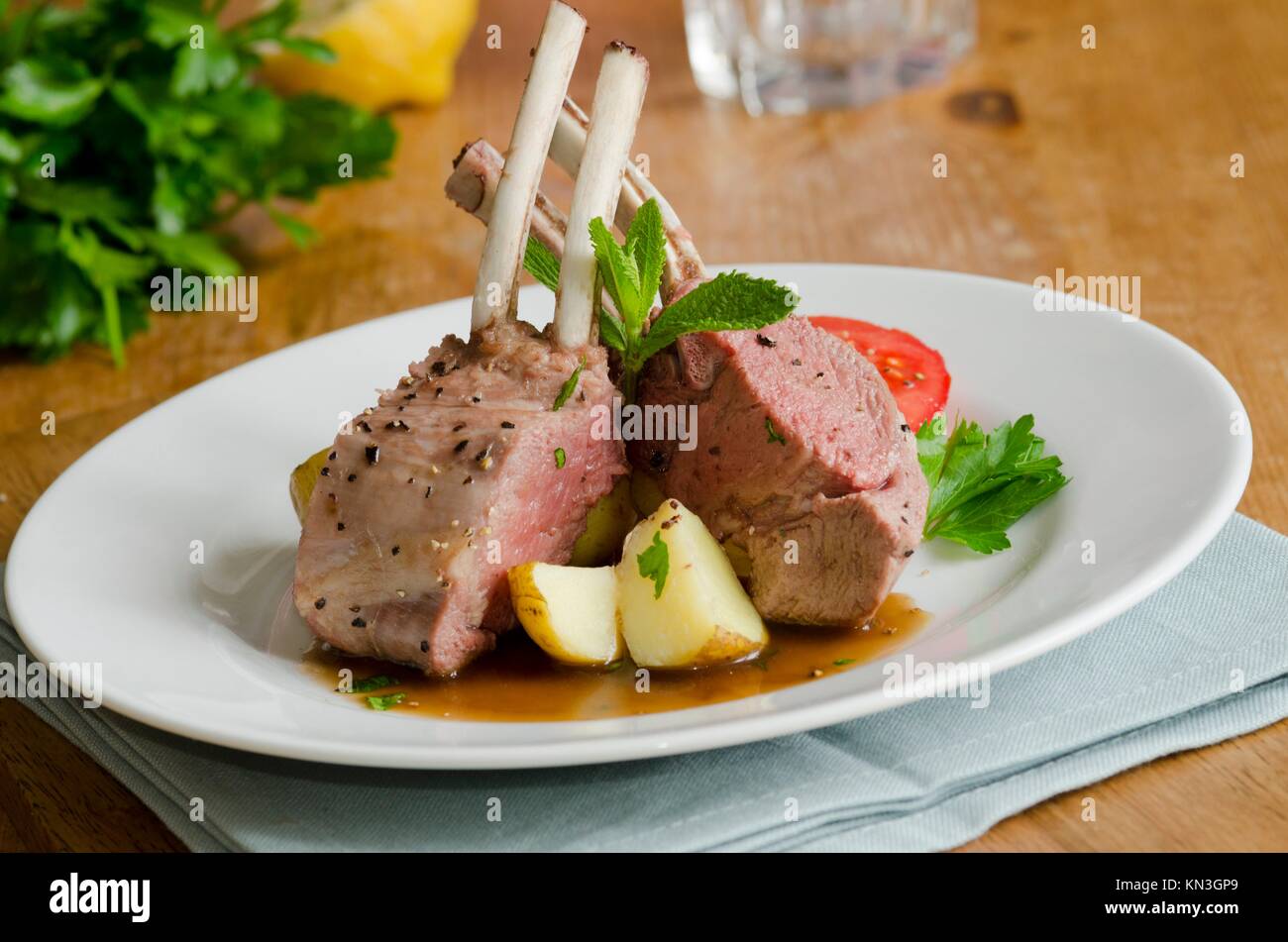 Grilled rack of lamb with gravy and new potatoes. Stock Photo