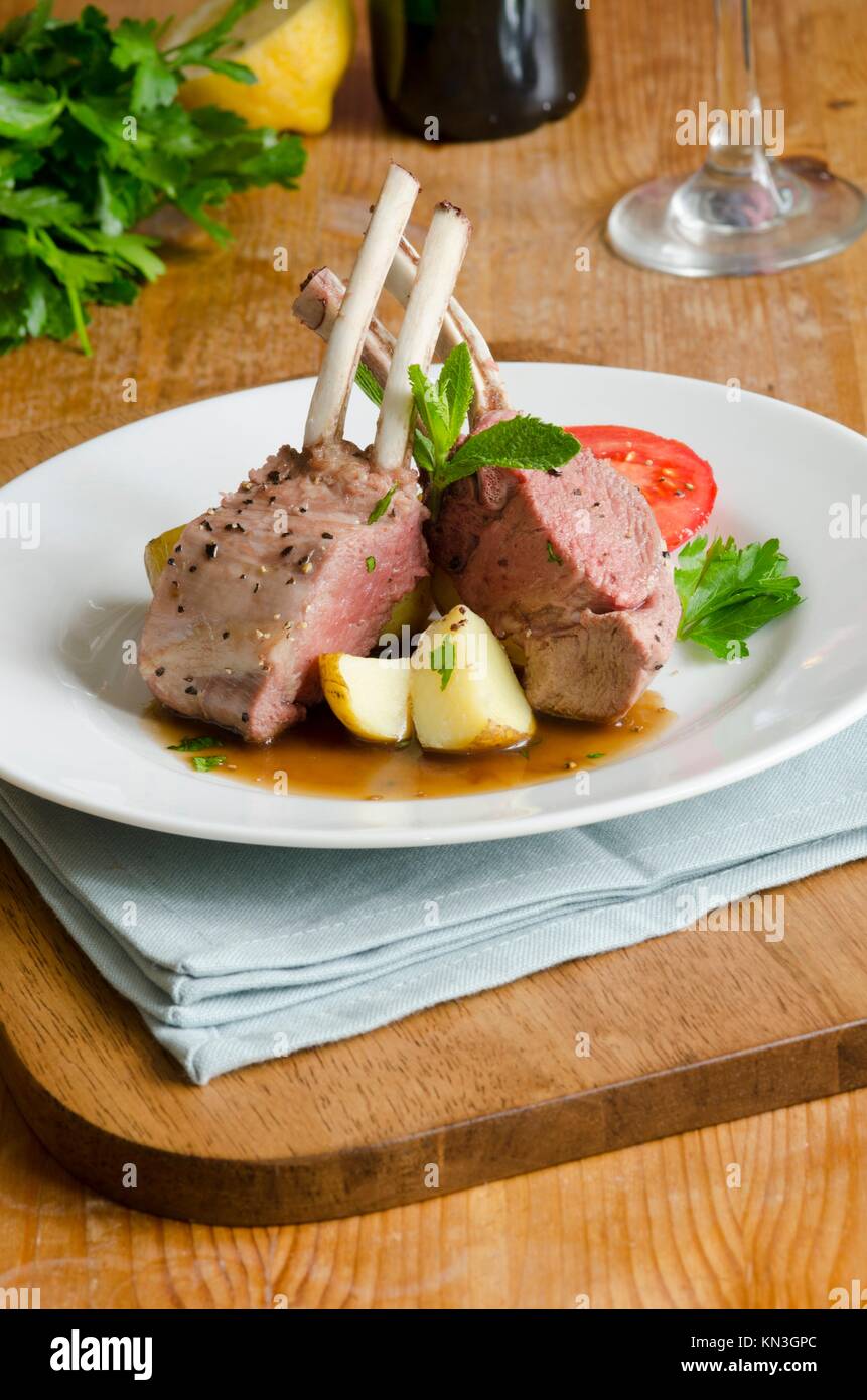 Grilled rack of lamb with gravy and new potatoes. Stock Photo