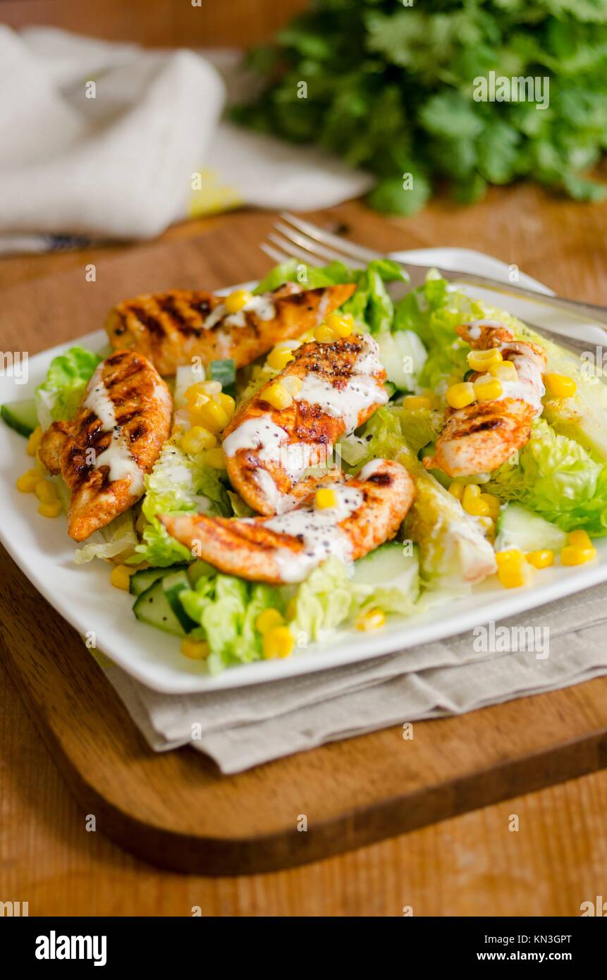 Griddled chicken, lettuce and corn on the cob salad. Stock Photo