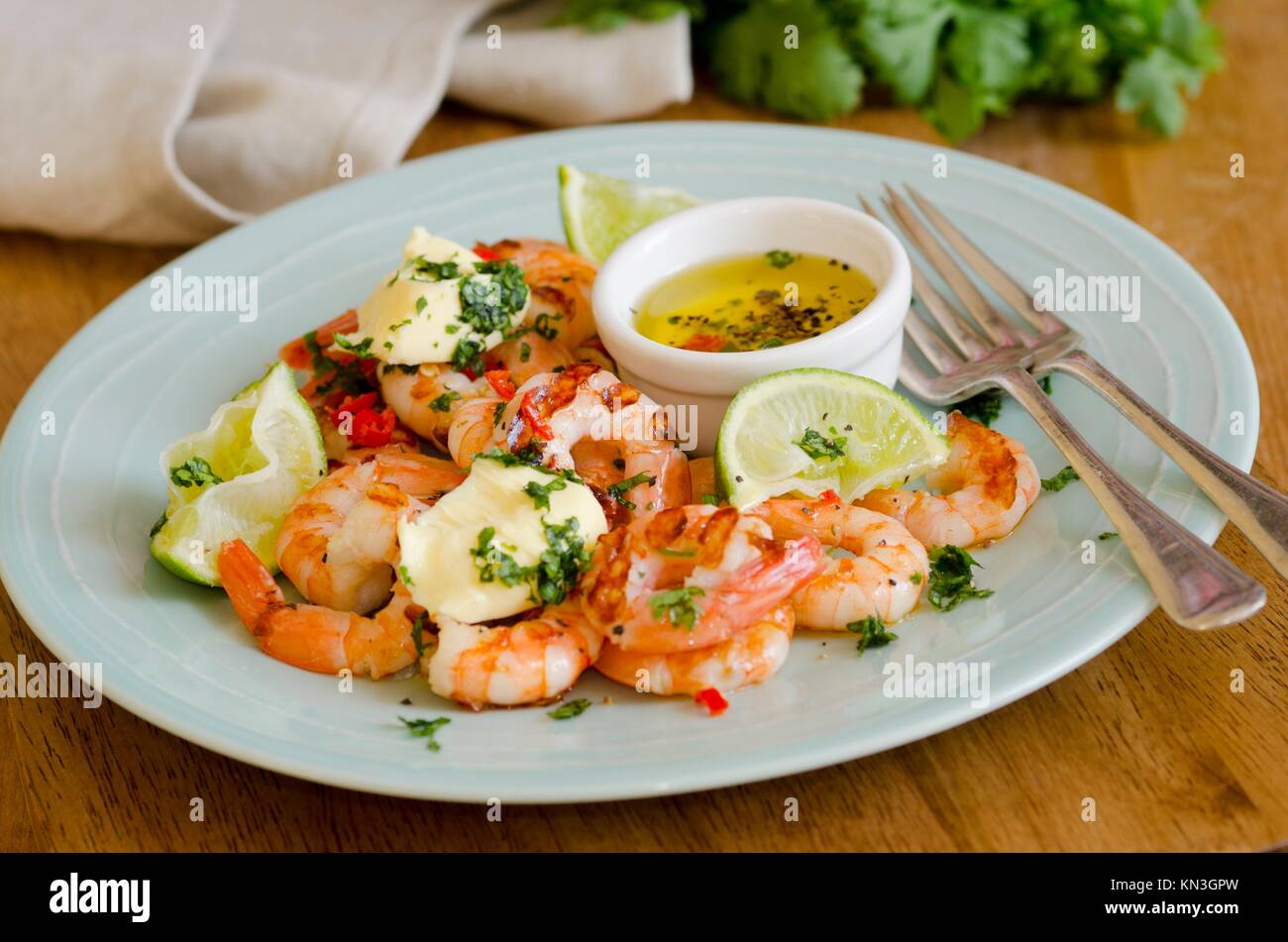 Barbecued prawns with chili, lime and coriander butter. Stock Photo