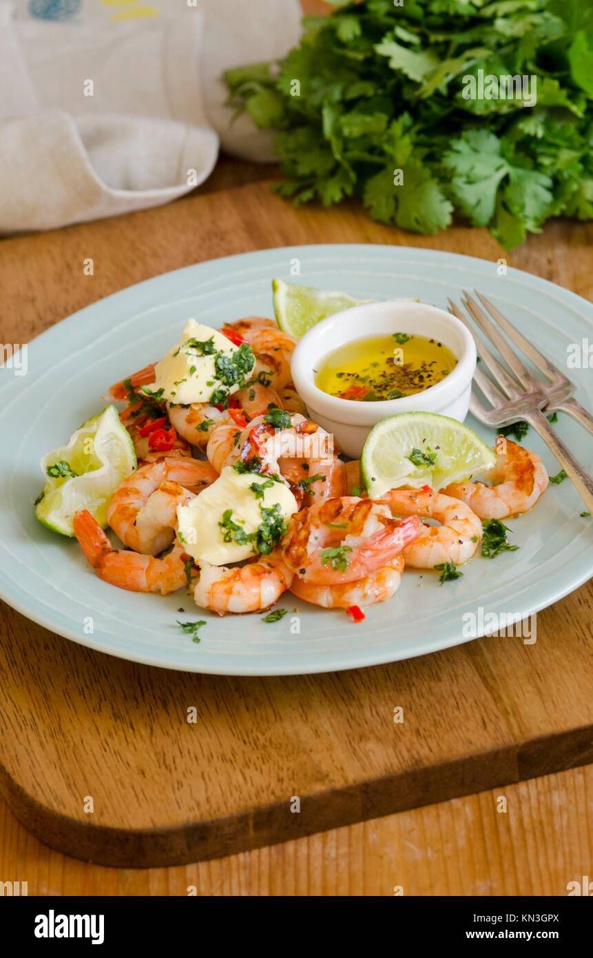 Barbecued prawns with chili, lime and coriander butter. Stock Photo
