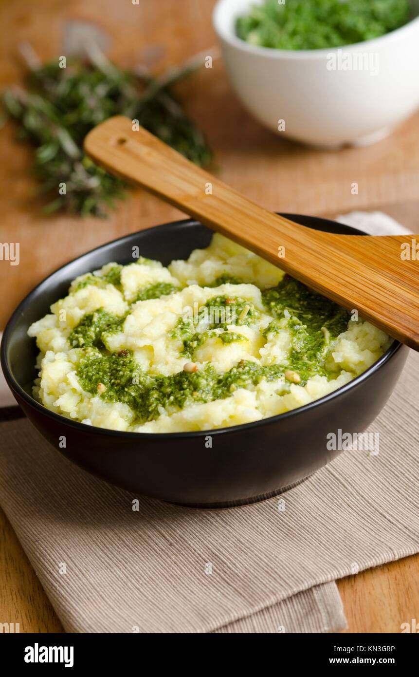 Mashed potatoes with pine nuts and pesto dressing. Stock Photo