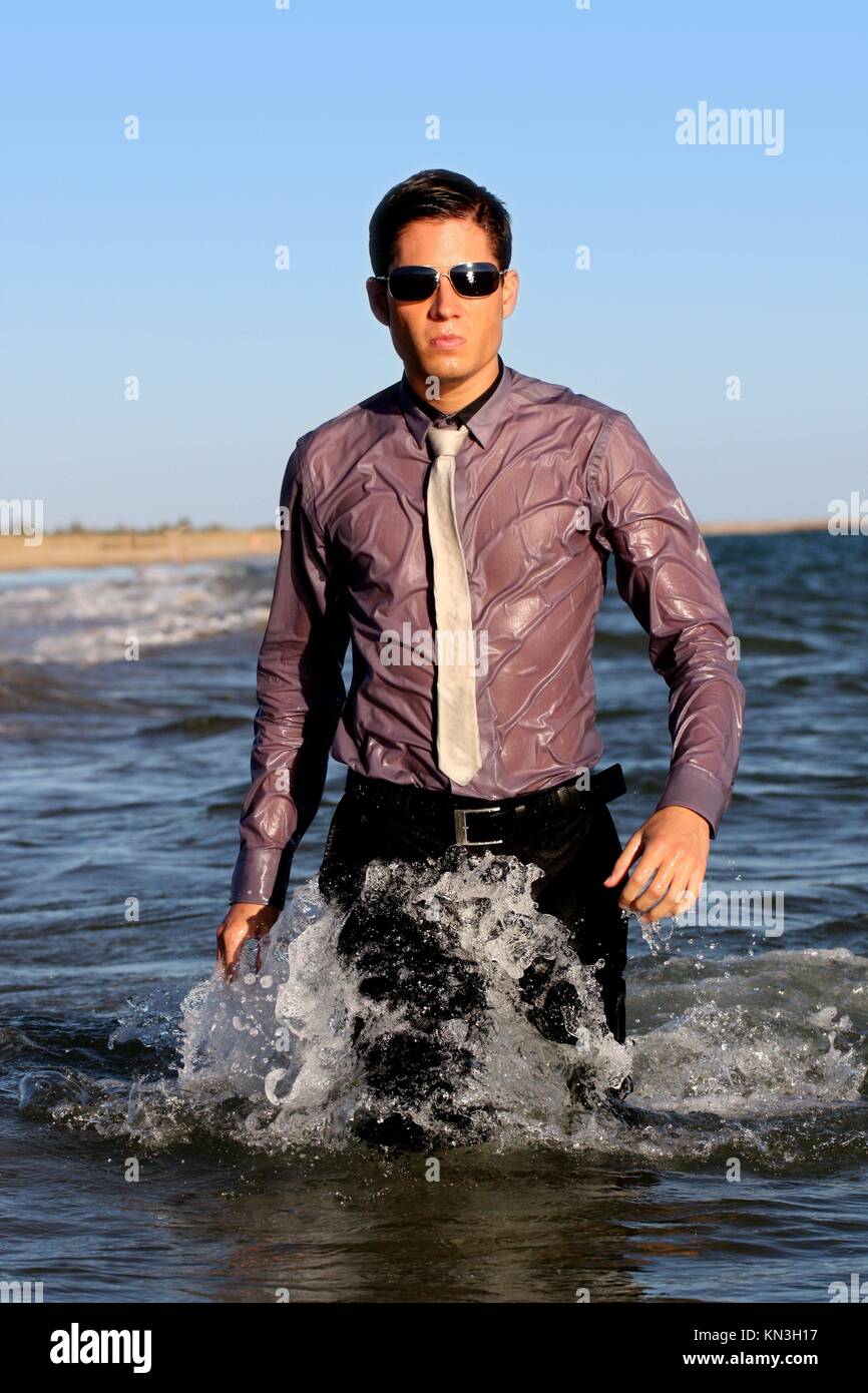 Fully dressed business man on the water Stock Photo - Alamy