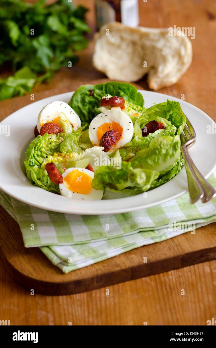 Salad of lettuce, chorizo and boiled eggs. Stock Photo