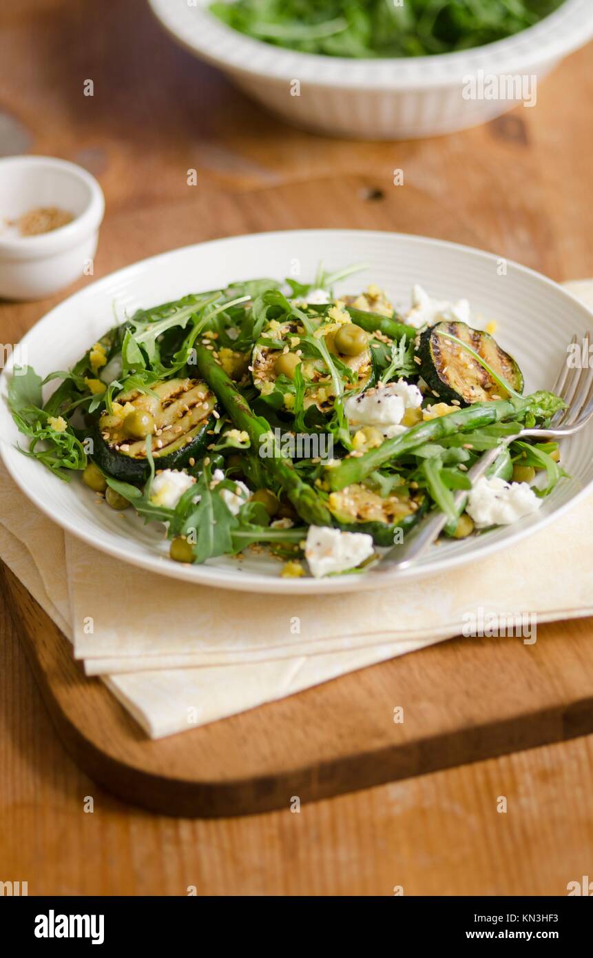 Asparagus and courgette salad with feta and sesame seeds. Stock Photo