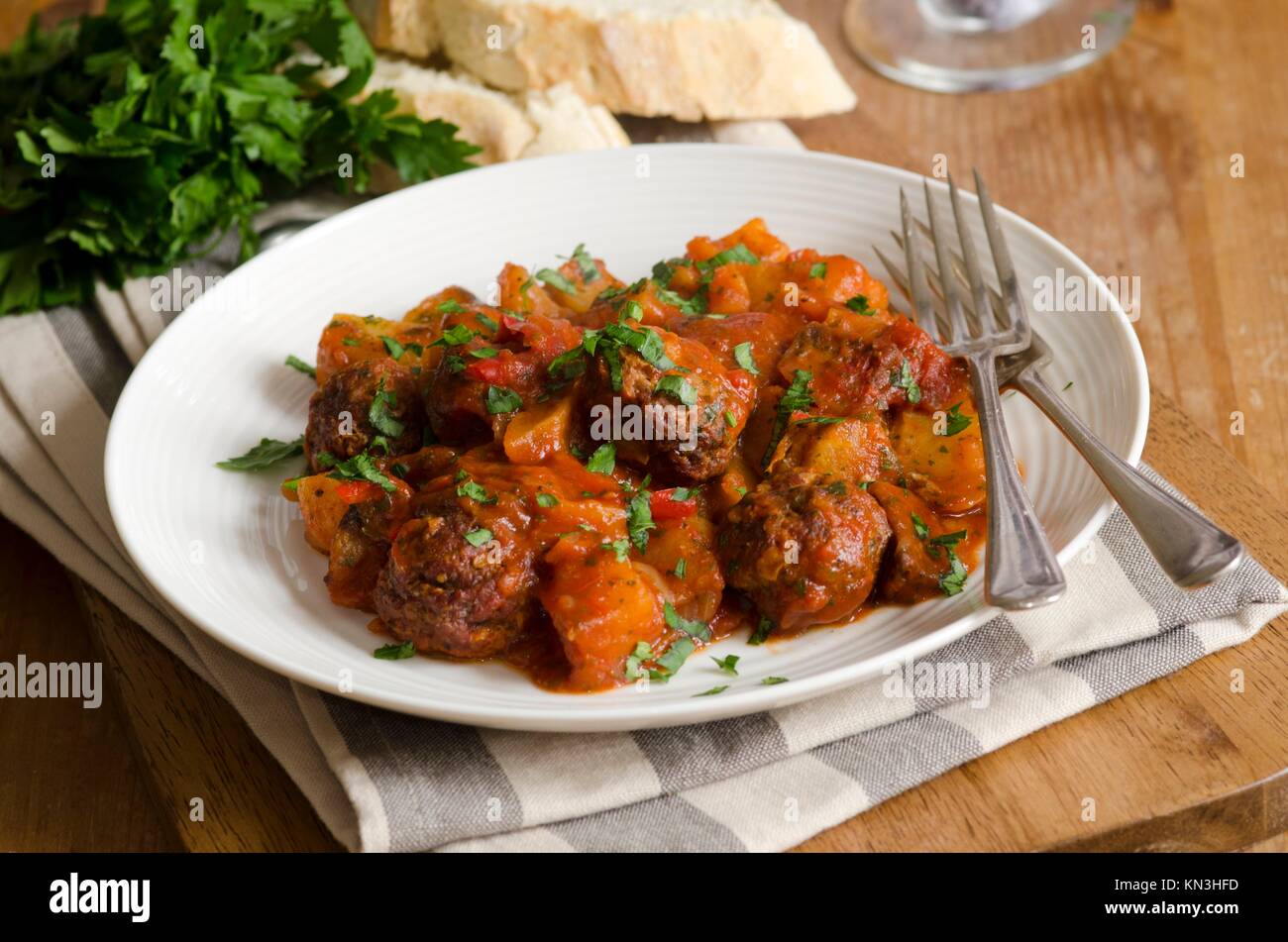 Meatballs Albondigas with potatoes and roast vegetables on a plate. Stock Photo
