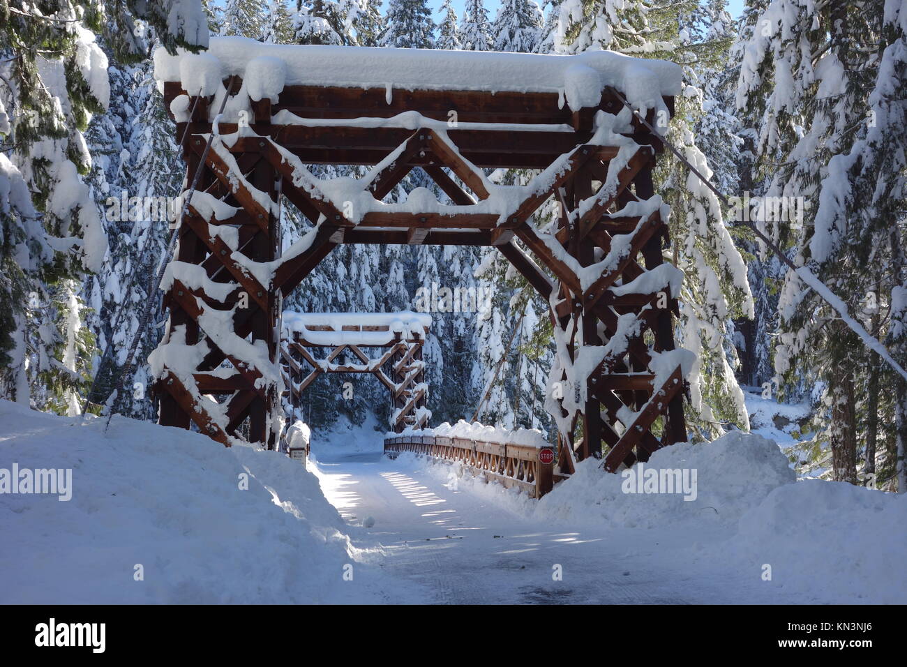 The Longmire Suspension Bridge is covered in snow during winter at the Mount Rainier National Park December 30, 2015 in Longmire, Washington.  (photo by NPS Photo via Planetpix) Stock Photo