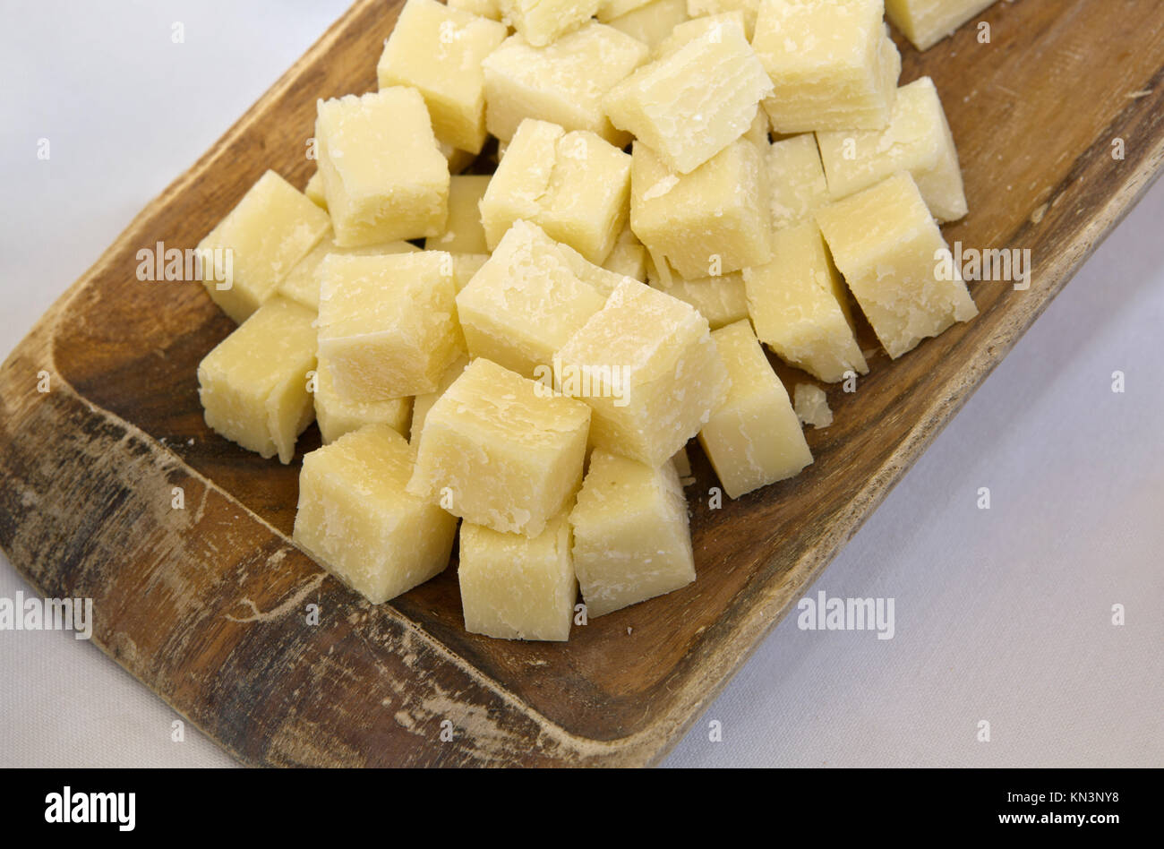 Cubes of aged sheep cheese on a wooden tray, Caceres, Spain. Stock Photo