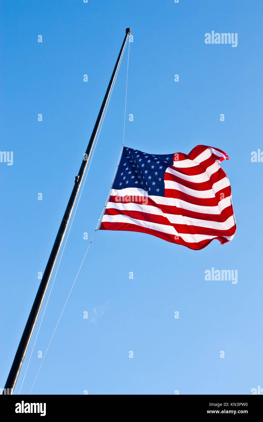 American flag on a blue sky during a windy day Stock Photo Alamy