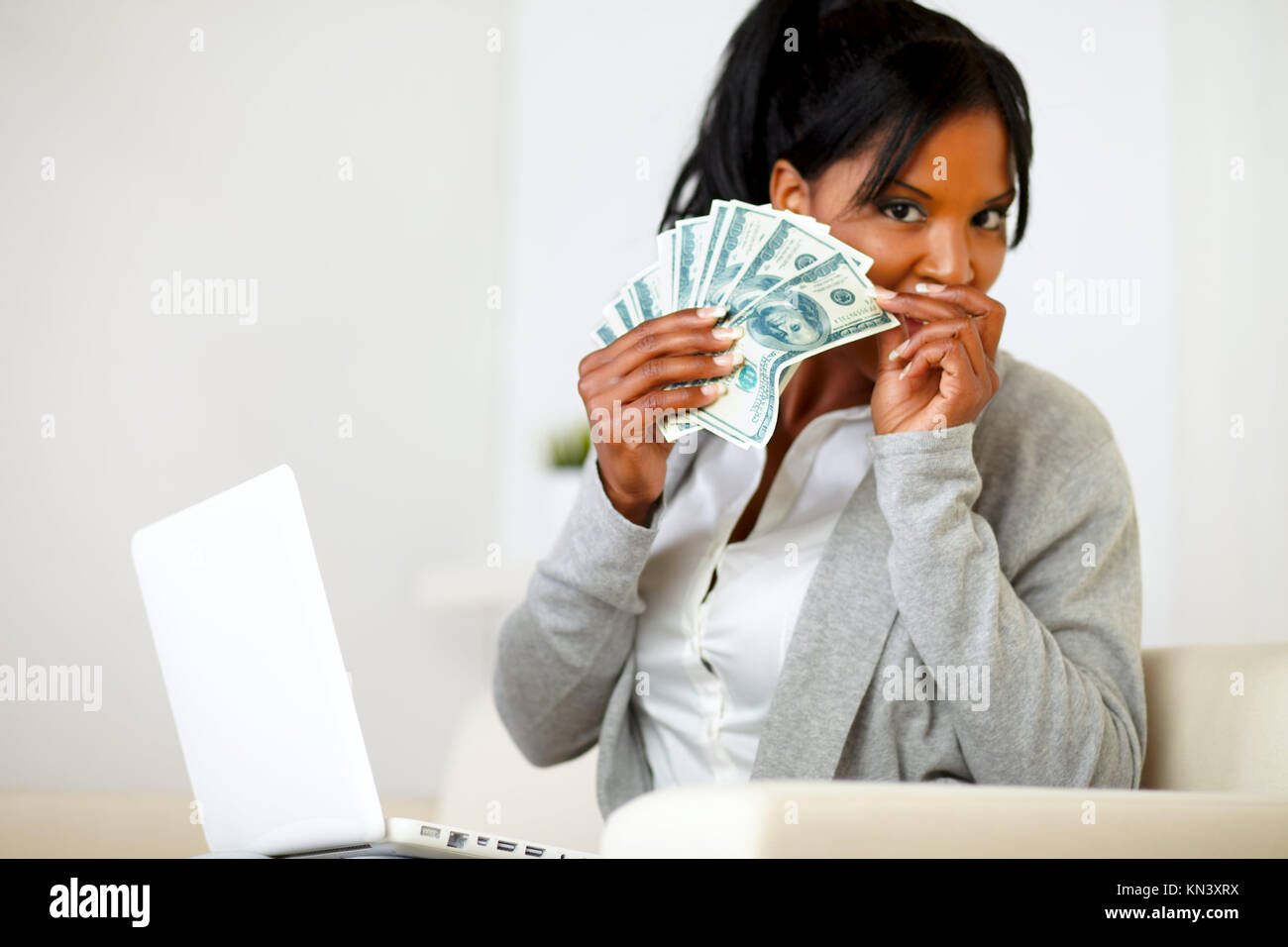 Portrait of an ambitious excited black woman with money. Stock Photo