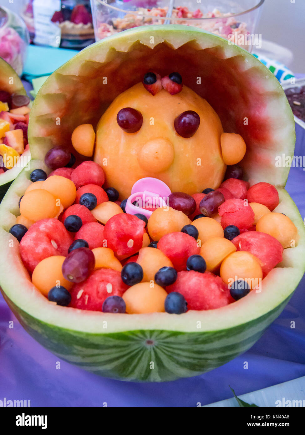 Colorful baby shower fruit sculpture made of various melons Stock Photo