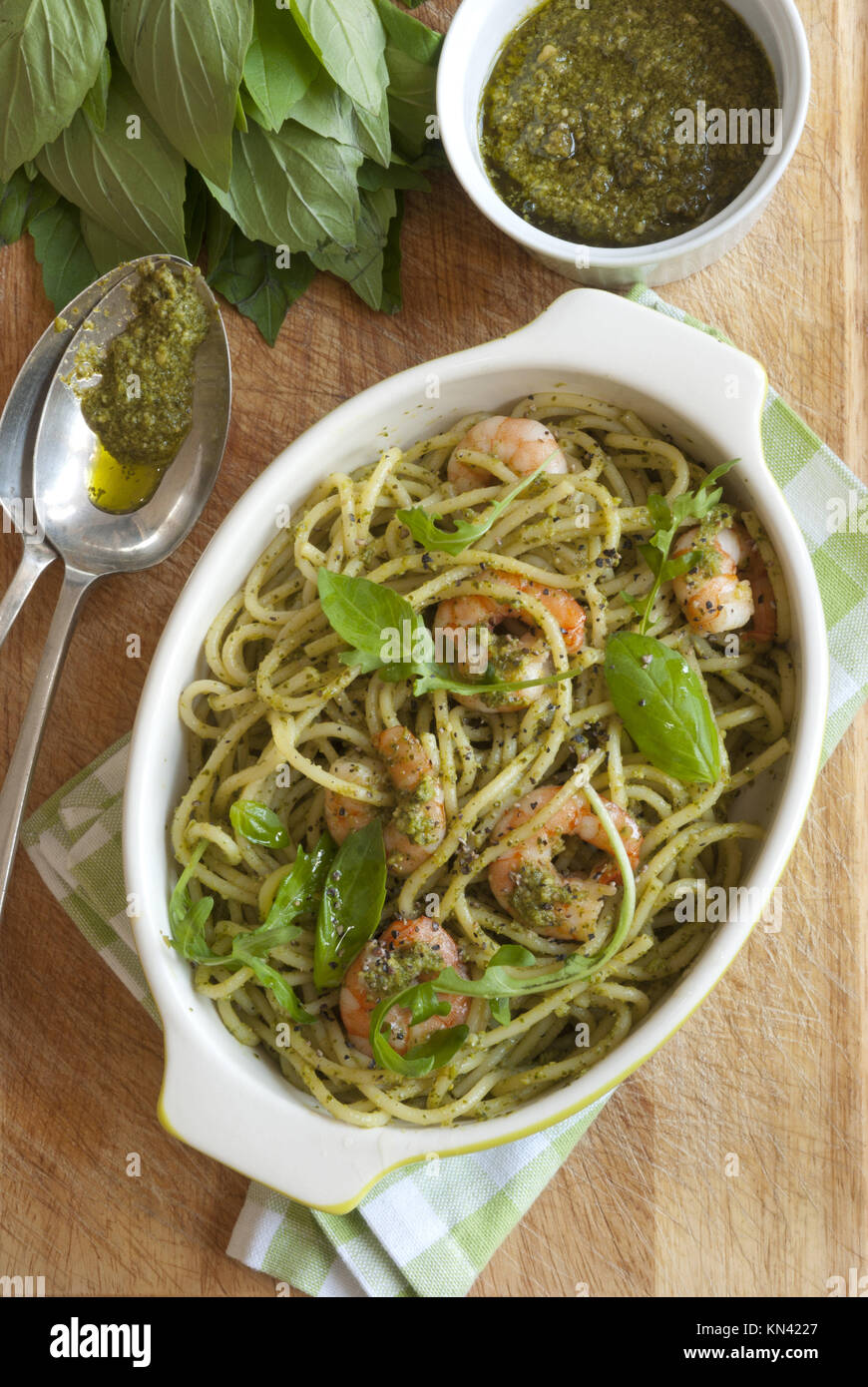 Spaghetti with king prawns and classic basil pesto sauce. Stock Photo