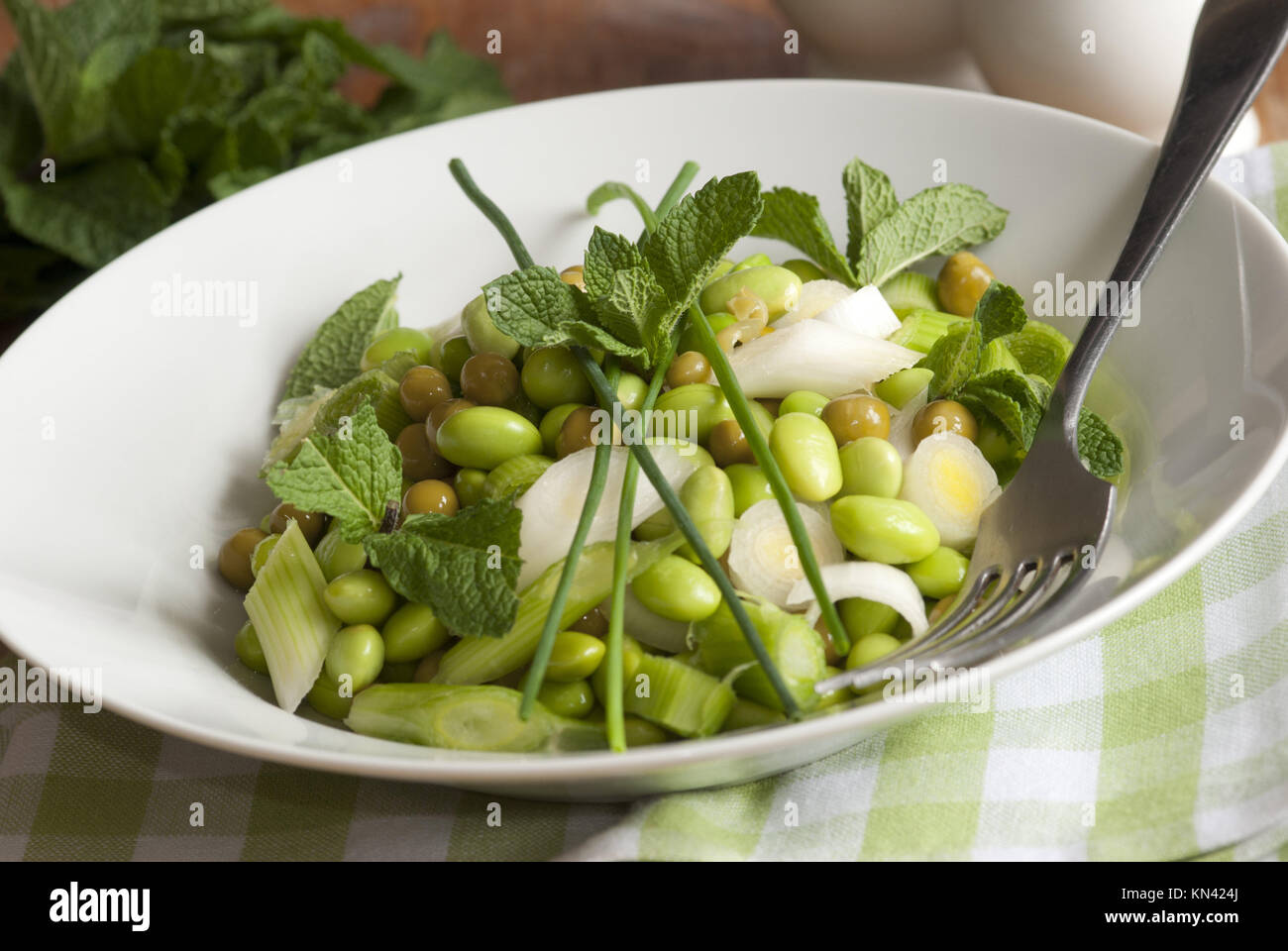 Broad bean, pea and spring onion salad topped with chives and mint