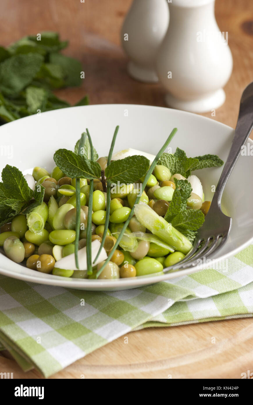 Broad bean, pea and spring onion salad topped with chives and mint