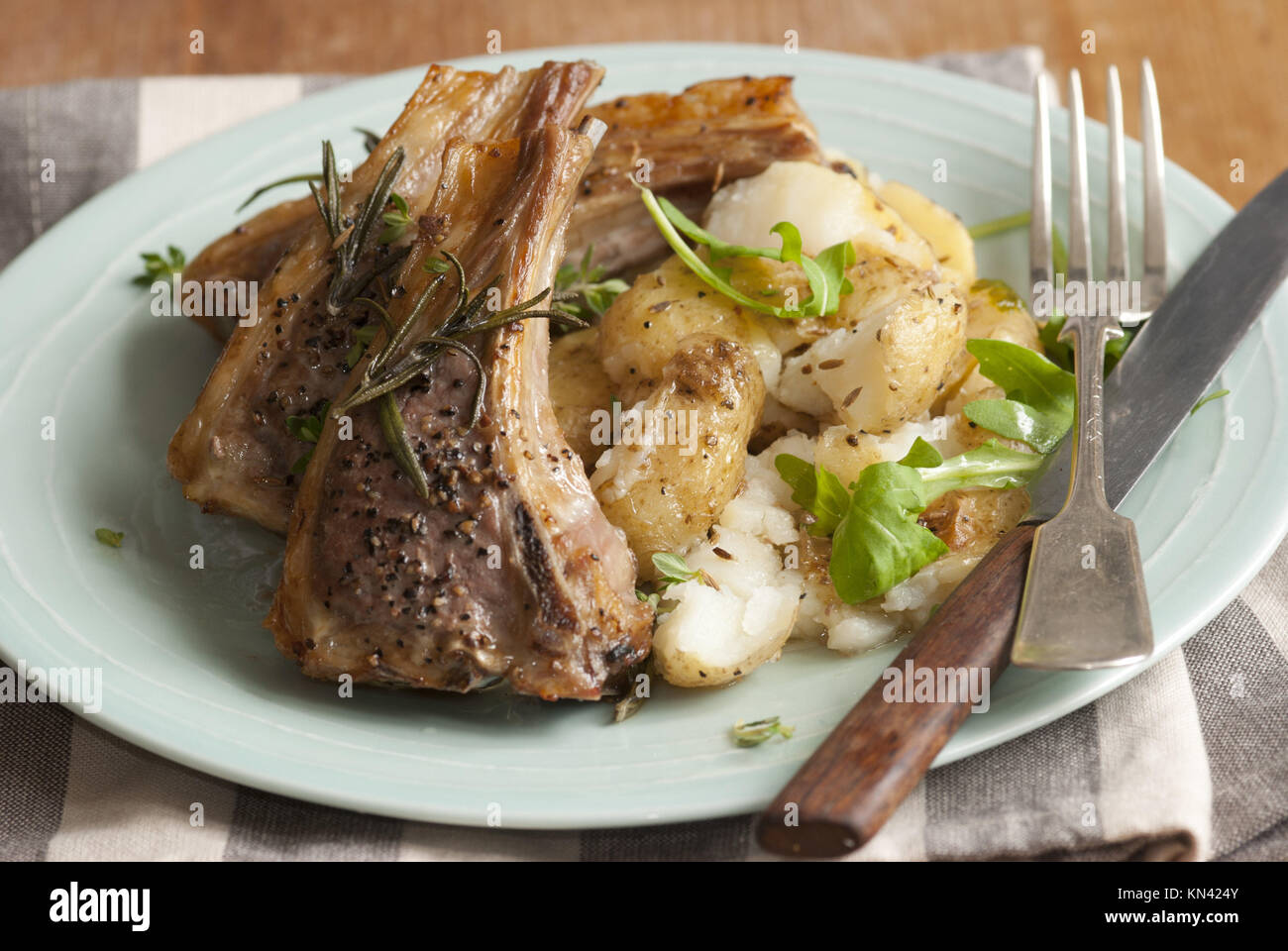 Lamb cutlets with crushed potatoes and rocket. Stock Photo