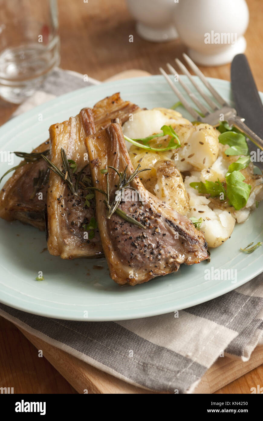 Lamb cutlets with crushed potatoes and rocket. Stock Photo