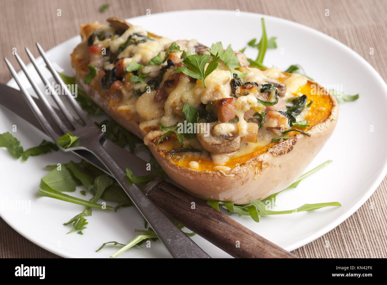 Baked butternut squash filled with spinach, bacon and cheese Stock